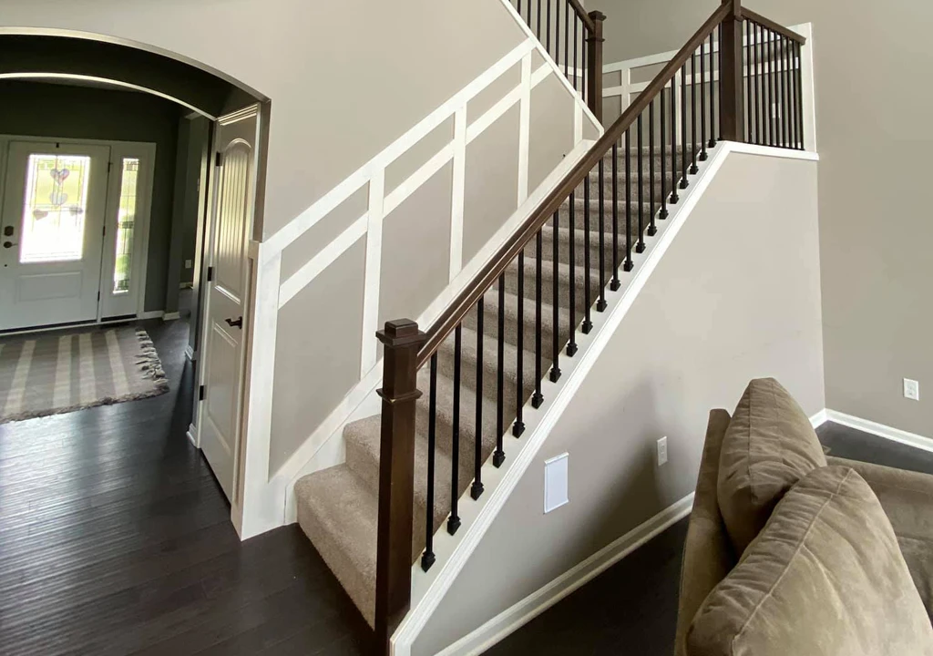 beautiful neutral paint color and white trim on carpeted staircase