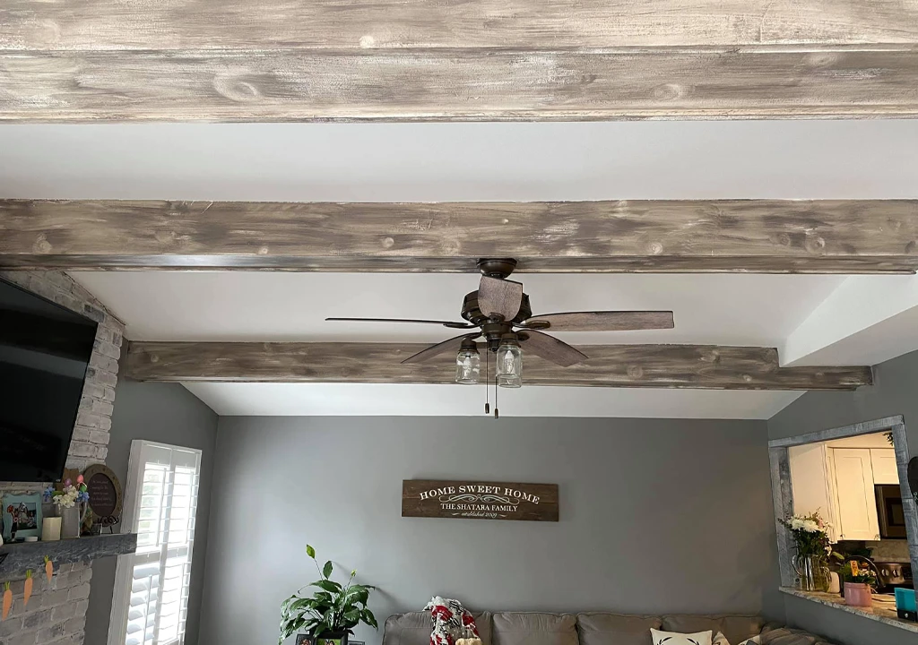 ceiling beam refinishing project and freshly painted walls in family room
