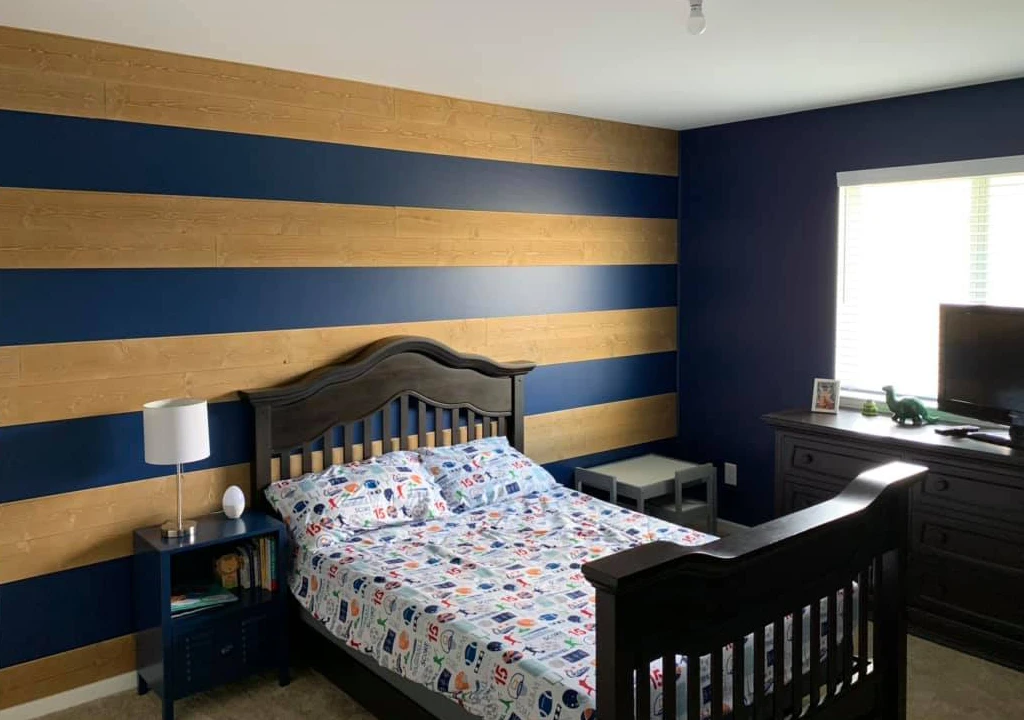 cool blue paint and wood striped accent wall in boys room