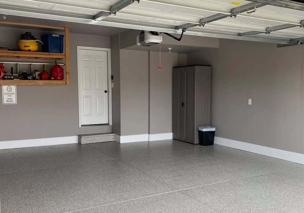 refinished garage with newly painted floors and grey walls