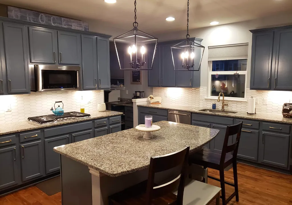 refinished kitchen cabinets with dark blue grey paint and white tile