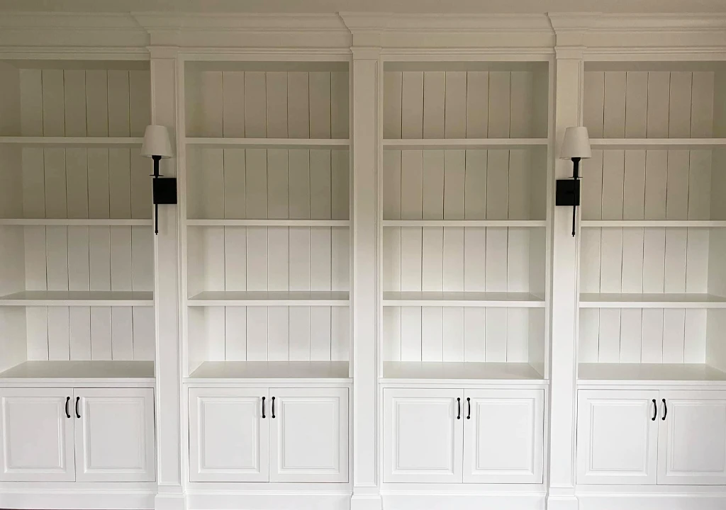 wall of refinished white bookshelves